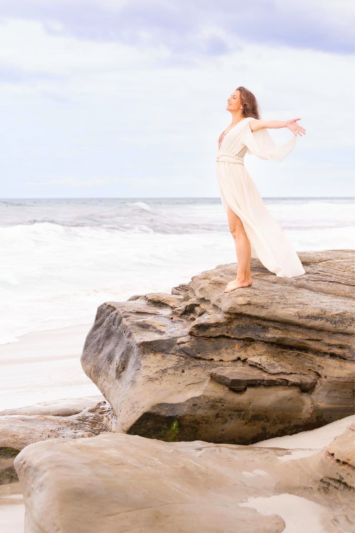 Woman walking barefoot along the shoreline